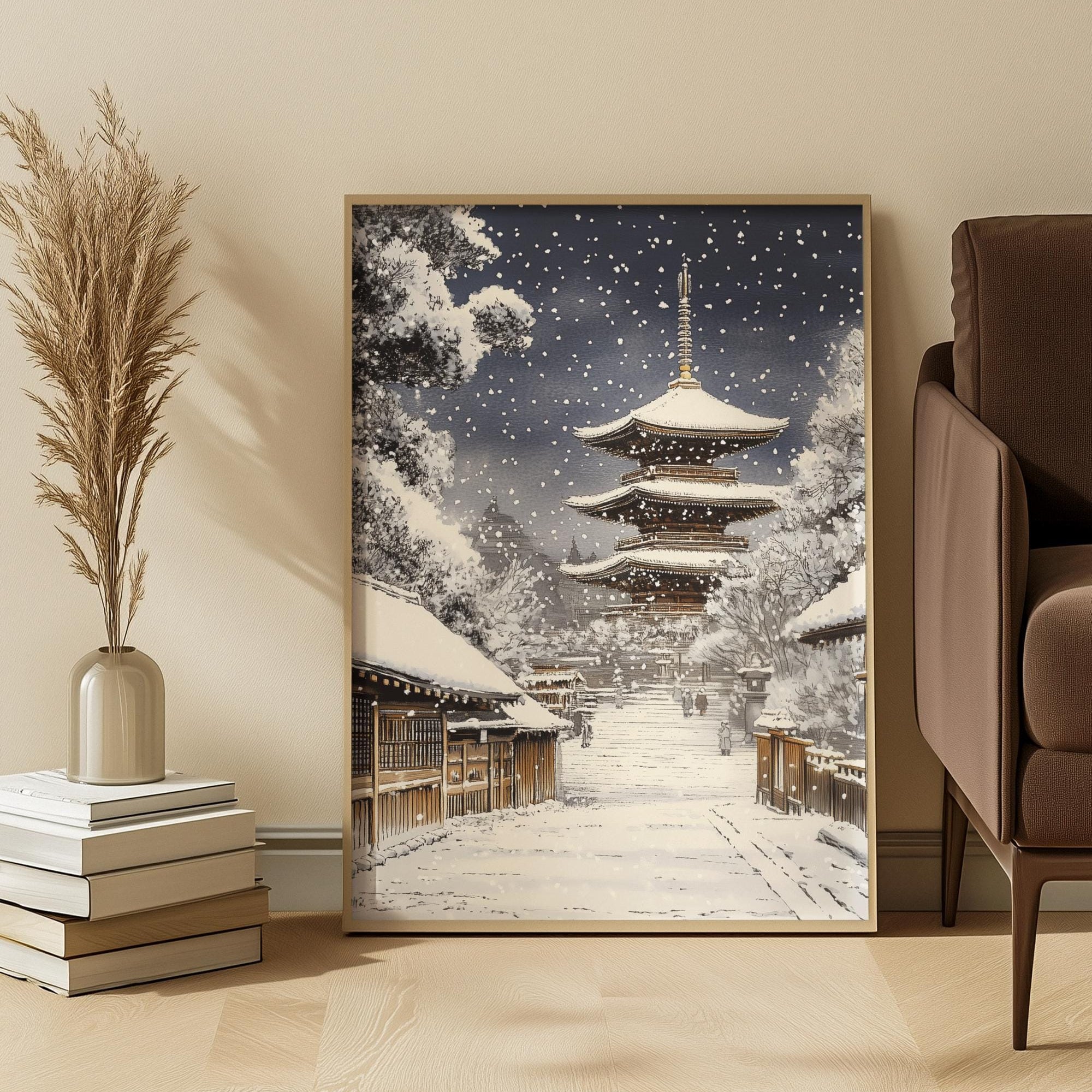 Framed artwork of a Japanese snowy pagoda in a room with a chair and decorative items.
