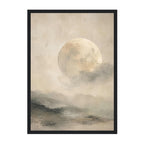 A framed art print depicting a large, textured moon glowing above misty, dark landscape hills under a cloudy sky, presented in a black frame against a white background.