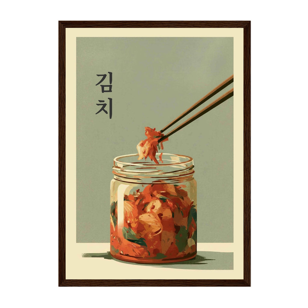A framed art print featuring a stylized illustration of Korean kimchi in a glass jar, with chopsticks lifting a piece of food from the jar. The print has a muted sage green background, black Korean text reading '생이' on the left, and is enclosed in a dark brown frame.