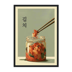 A framed art print featuring a stylized illustration of Korean kimchi in a glass jar, with chopsticks lifting a piece. The print has a muted sage green background, black Korean text reading '생이', and a cream border with a thin black frame.