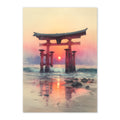 Traditional Japanese torii gate at sunset on a beach