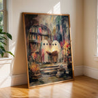 A large framed art print leaning against a beige wall on a wooden floor, showing two white ghosts reading in a library. The room has two windows with sunlight streaming in and a green plant on the left.
