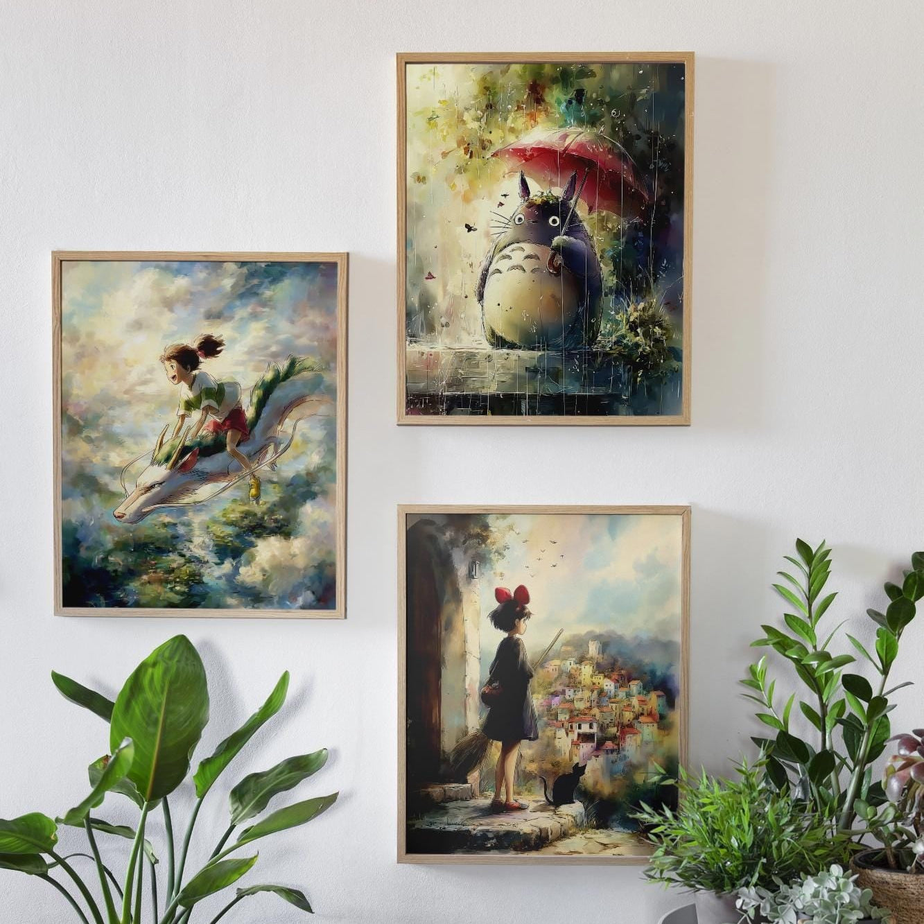 Three framed artworks on a wall with plants around