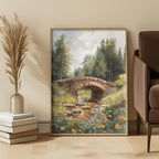 Framed nature painting of a meadow with a bridge over a stream in a room with decor elements.