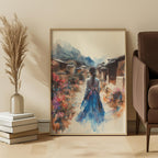 Framed artwork of a korean woman in a blue hanbok walking through a village scene, placed on a wall in a room with a chair and decorative items.
