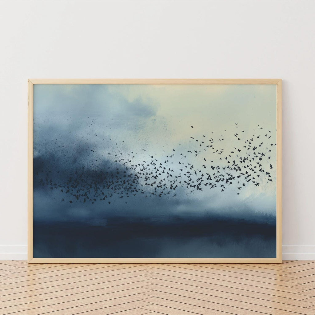 Framed artwork of birds flying over water with a wooden floor and white wall background