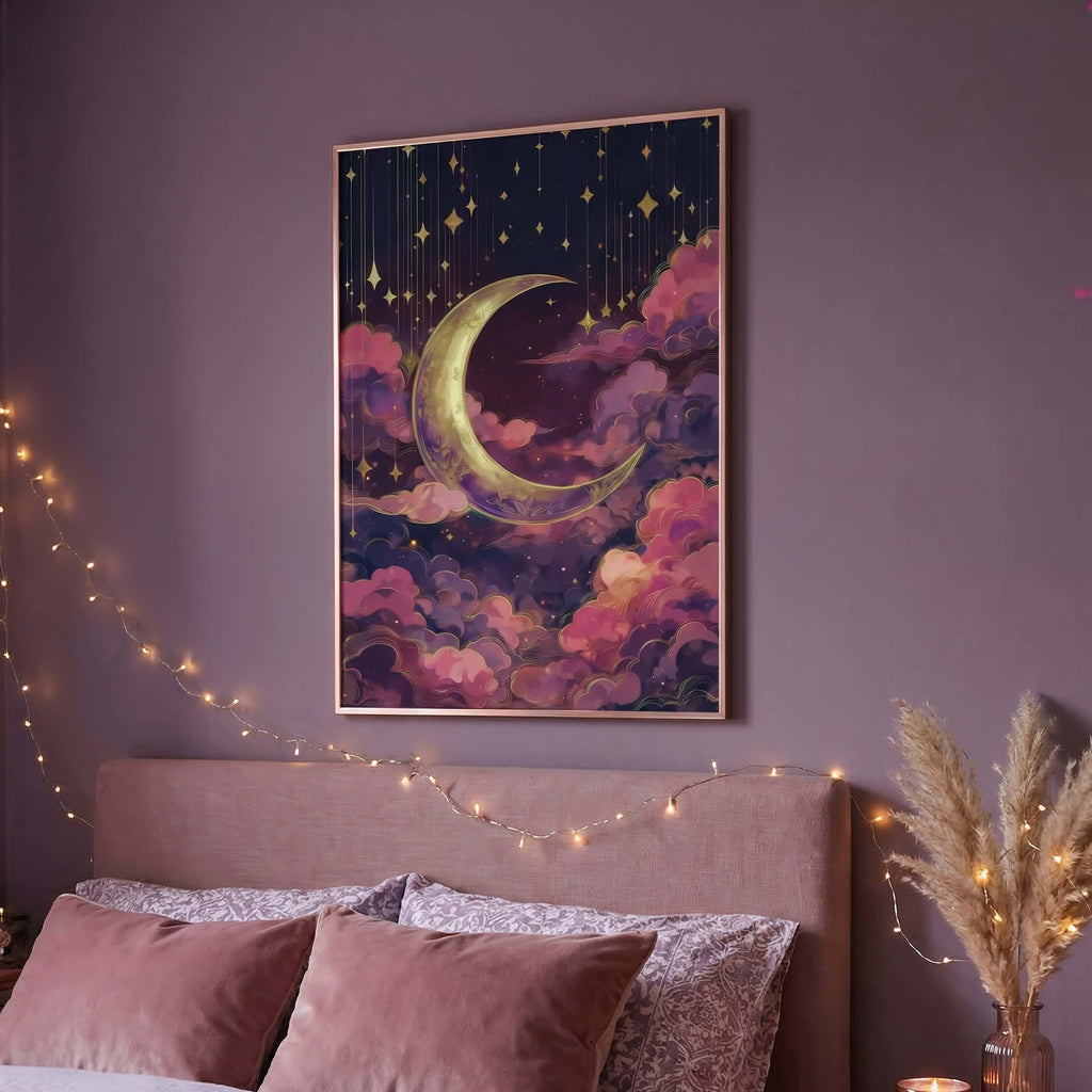 A framed wall art print featuring a crescent moon and stars in a dreamy purple, pink, and navy sky, displayed above a bed in a cozy bedroom setting with string lights and candles.